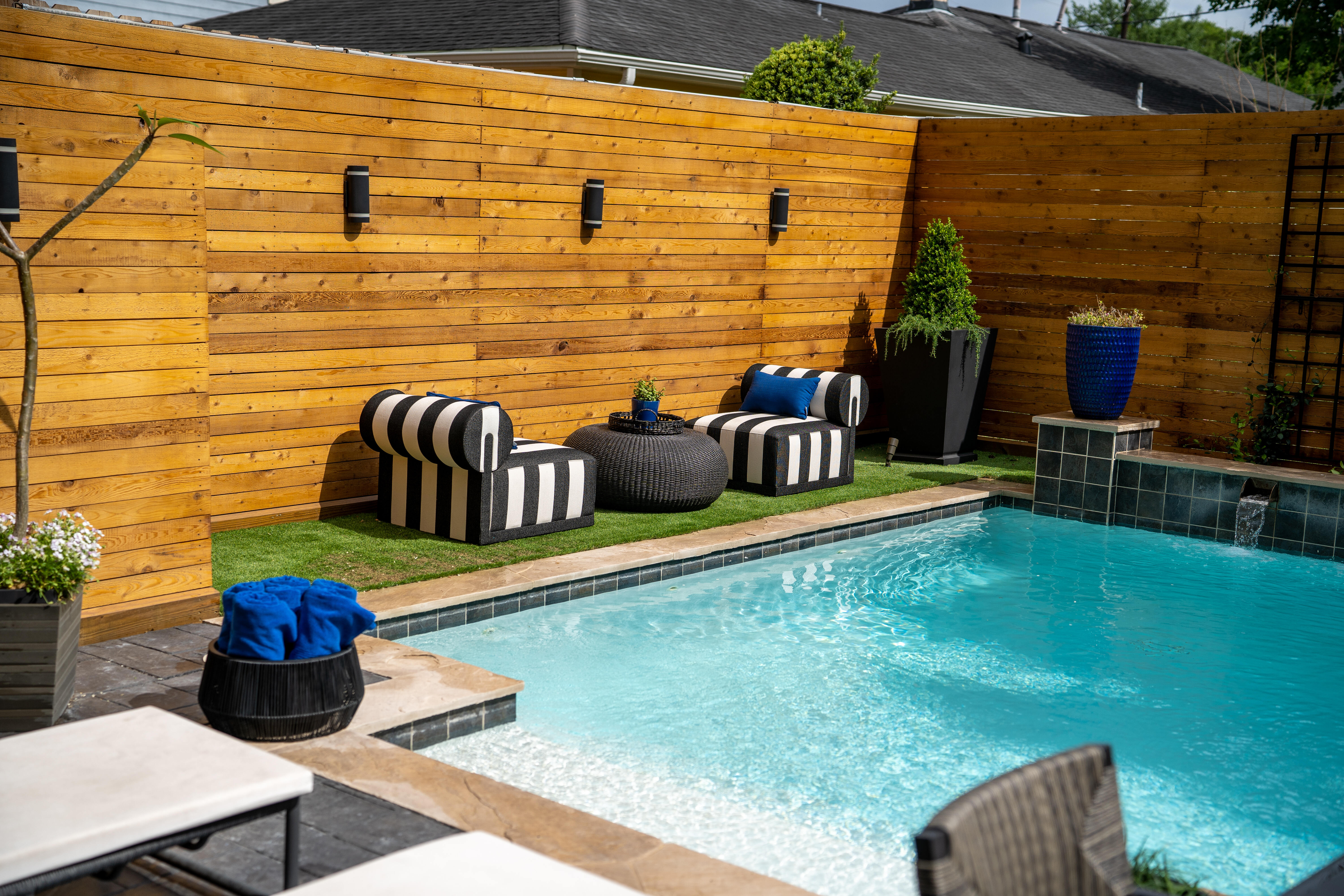 Custom pool with outdoor seating and wood fence Houston — Matt Baker Contracting
